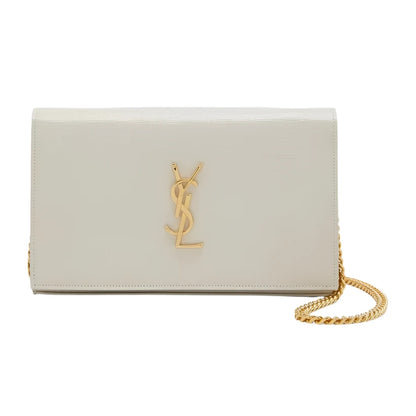White YSL handbag with gold chain and logo on a light gray background