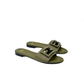 Pair of green sandals with buckles on a white background