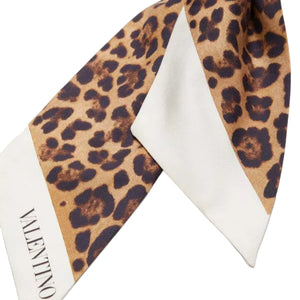 Leopard print scarf on a white background with 'Valentino' branding.