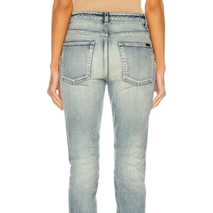 Light blue jeans worn by a person on a white background