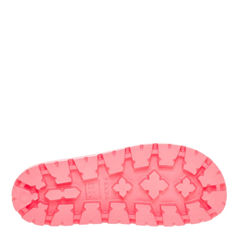 Close-up of a pink shoe sole with tread pattern on a white background