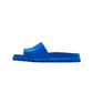 Blue slide sandal on a white background with 'www.goat.com' in the URL bar.
