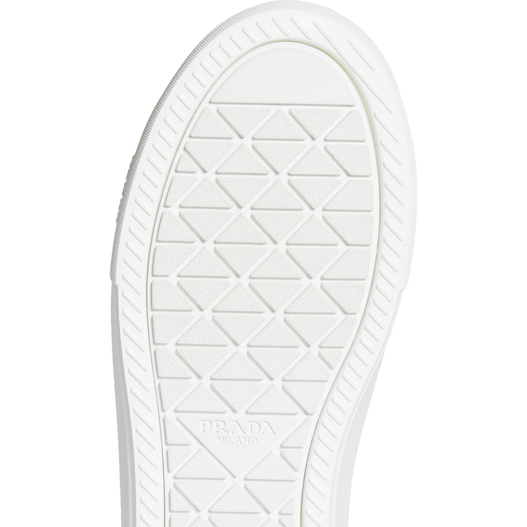 White sneaker sole with a diamond pattern on a white background