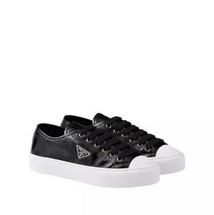 Black sneakers with white soles on a white background