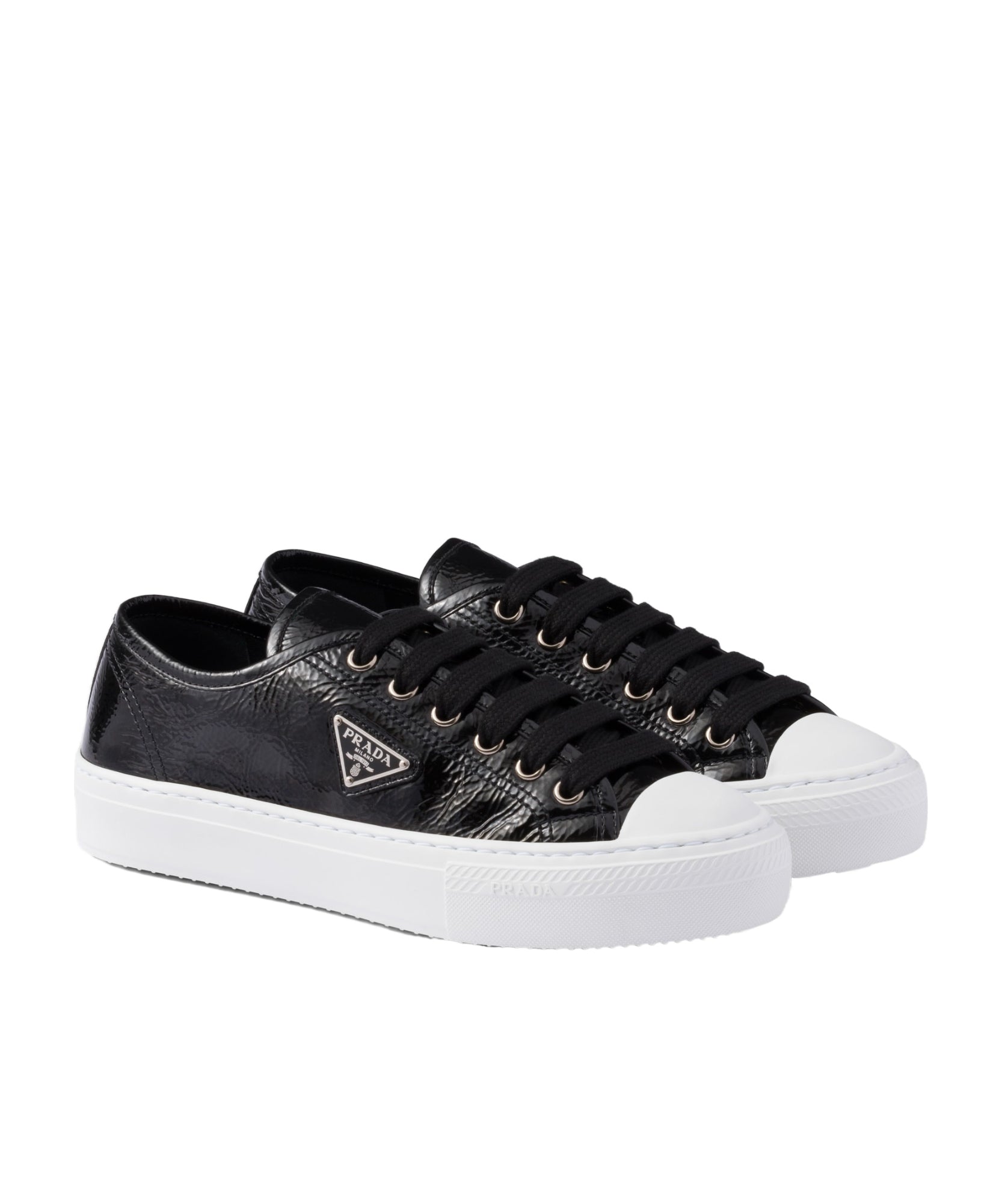 Black sneakers with white soles on a white background