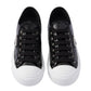 Black sneakers with white soles on a white background