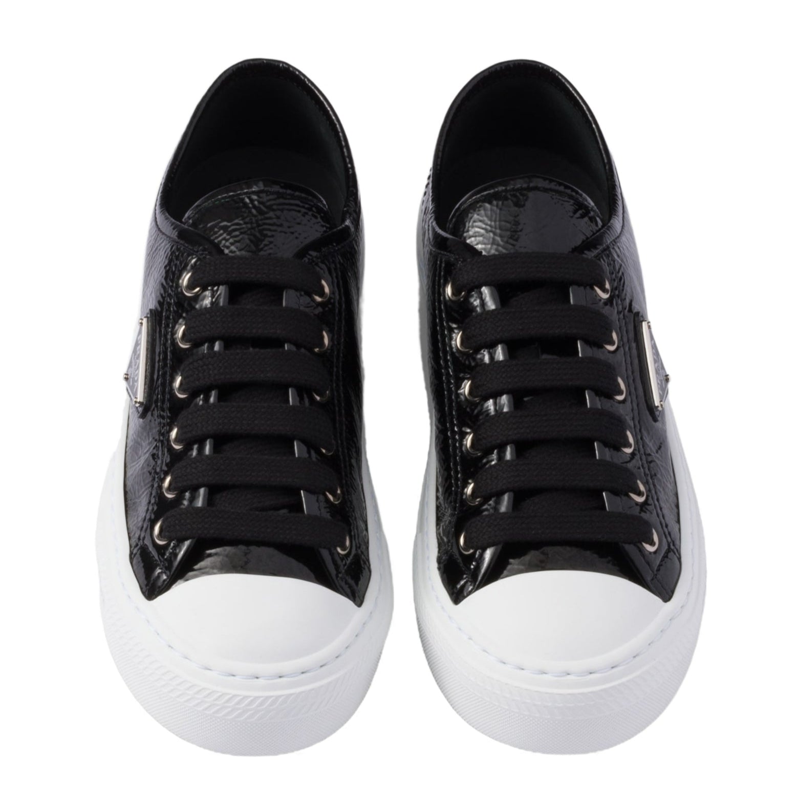 Black sneakers with white soles on a white background