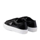 Black sneakers with white soles on a white background