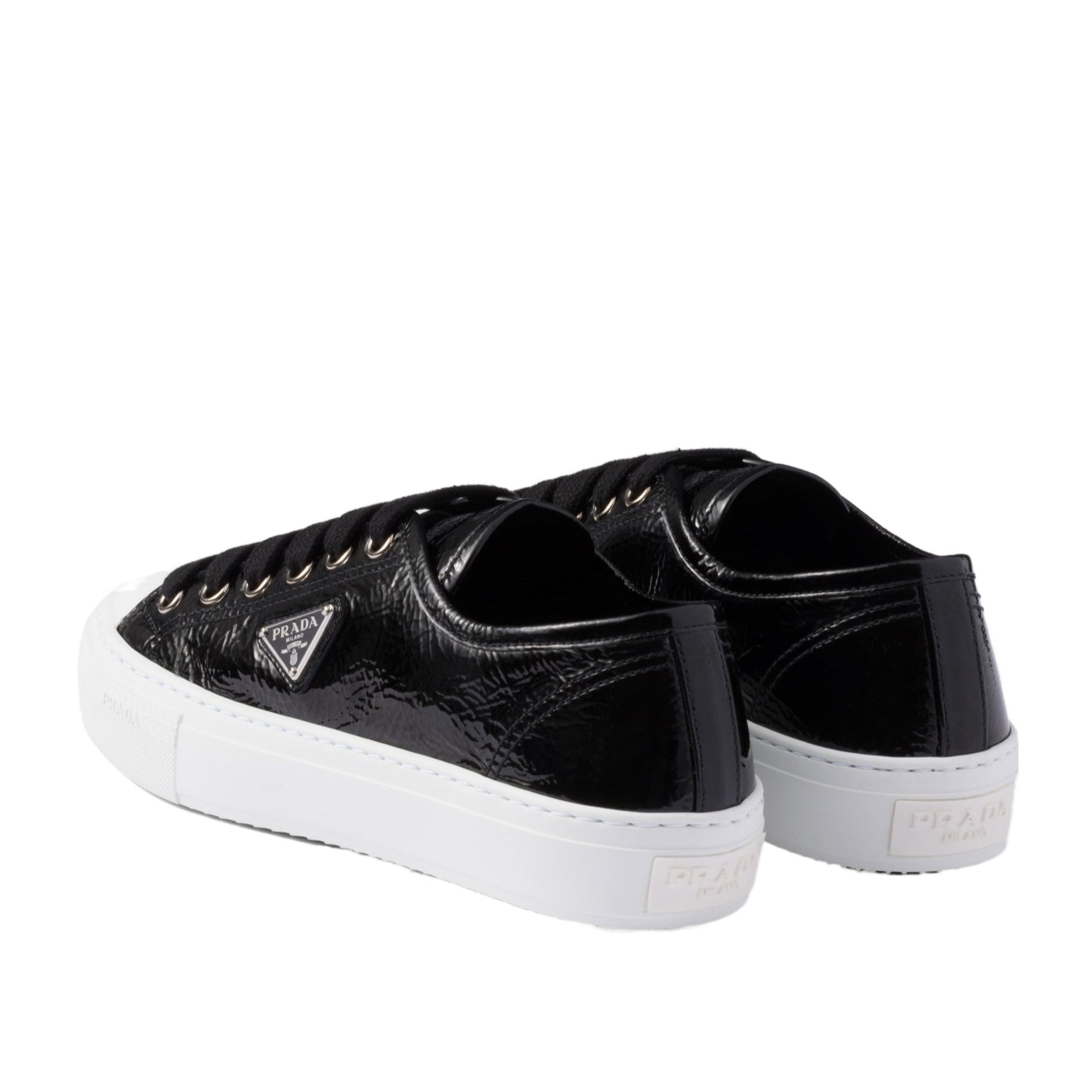 Black sneakers with white soles on a white background