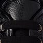 Close-up of a black winter boot with textured sole and lace-up design.