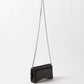 Black handbag with a chain strap on a white background