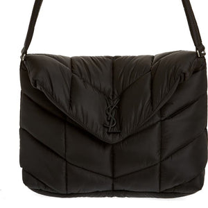 Black puffer bag with a brand logo on a white background