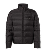 Black puffer jacket on a light gray background