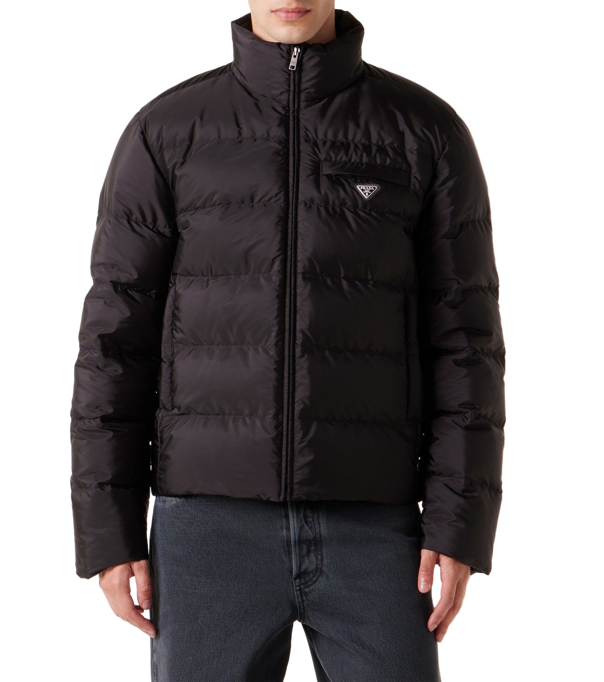 Black puffer jacket worn by a person on a light gray background