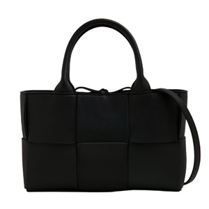Black woven Bottega Veneta handbag on a white background