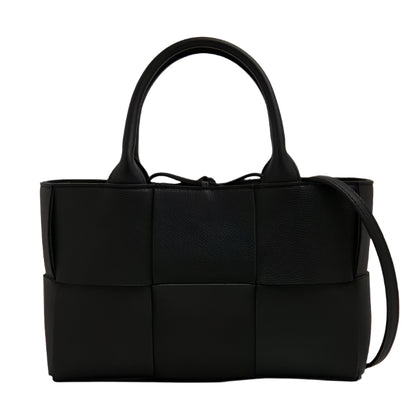 Black woven Bottega Veneta handbag on a white background