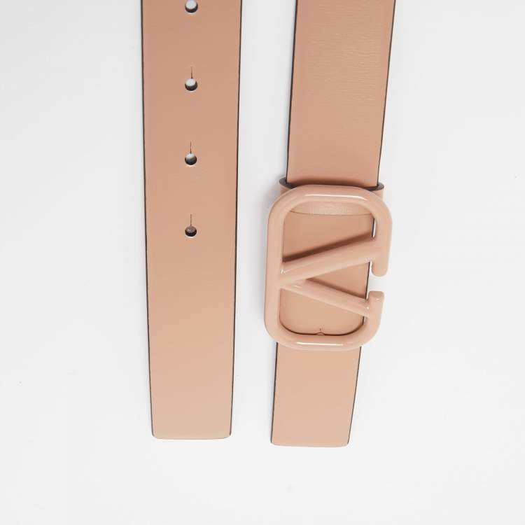 Beige belt with a rose gold buckle on a light gray background