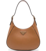 Brown Prada handbag on a white background