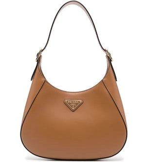 Brown Prada handbag on a white background