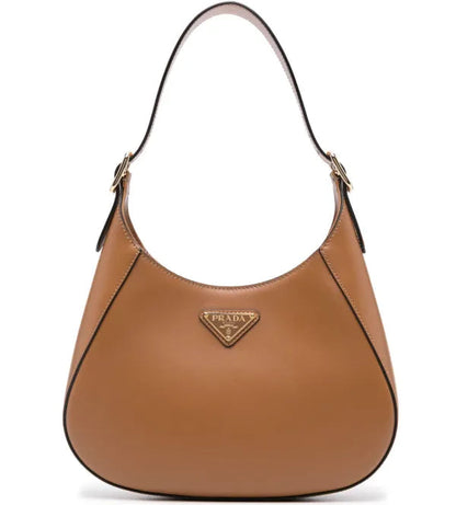 Brown Prada handbag on a white background