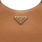 Close-up of a brown Prada handbag with the brand logo.