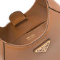 Brown Prada handbag with gold hardware on a white background