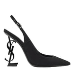 Black high-heeled shoe with a unique heel design on a white background