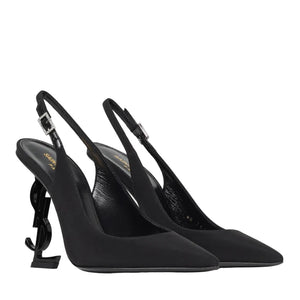 Pair of black high-heeled slingback shoes on a light gray background