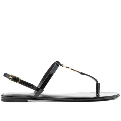 Black sandal with thin strap on a white background