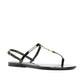 Black sandal with thin straps on a white background