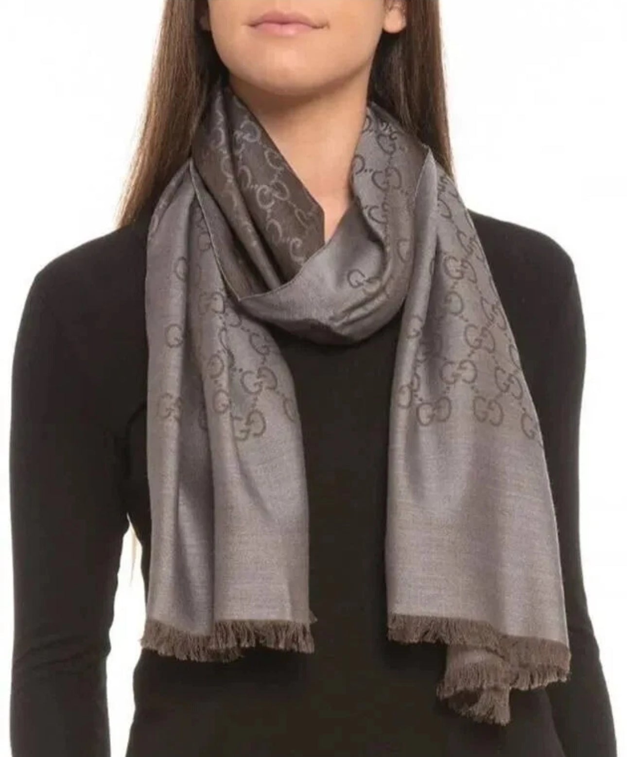 Person wearing a gray patterned scarf on a white background