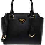 Black Prada handbag with gold accents on a white background