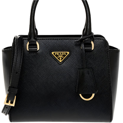 Black Prada handbag with gold accents on a white background