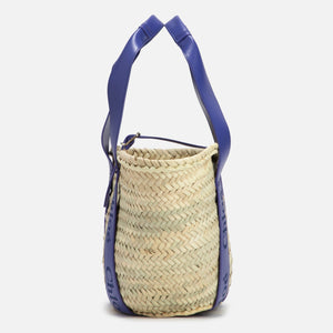 Woven basket with blue handles on a white background