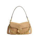 Beige handbag with gold chain and hardware on a light gray background