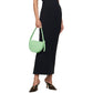 Woman wearing a black strapless dress holding a green luxury Bottega handbag on a white background