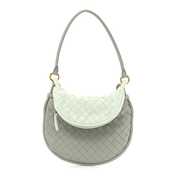 Luxury Bottega Veneta Gray handbag with a light green woven top section on a white background