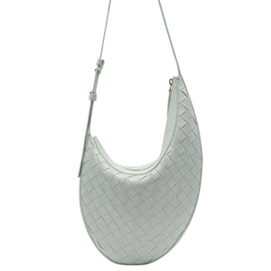 Light blue woven handbag on a light gray background