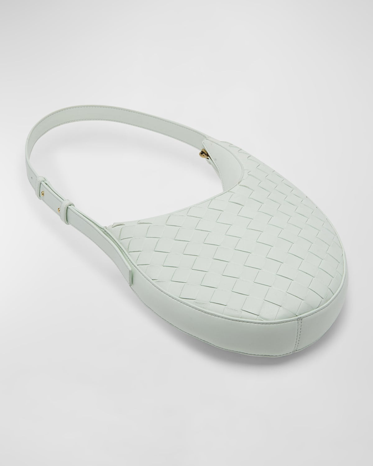 Light green woven luxury bottega handbag on a white background