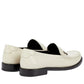 White loafers with black soles on a white background