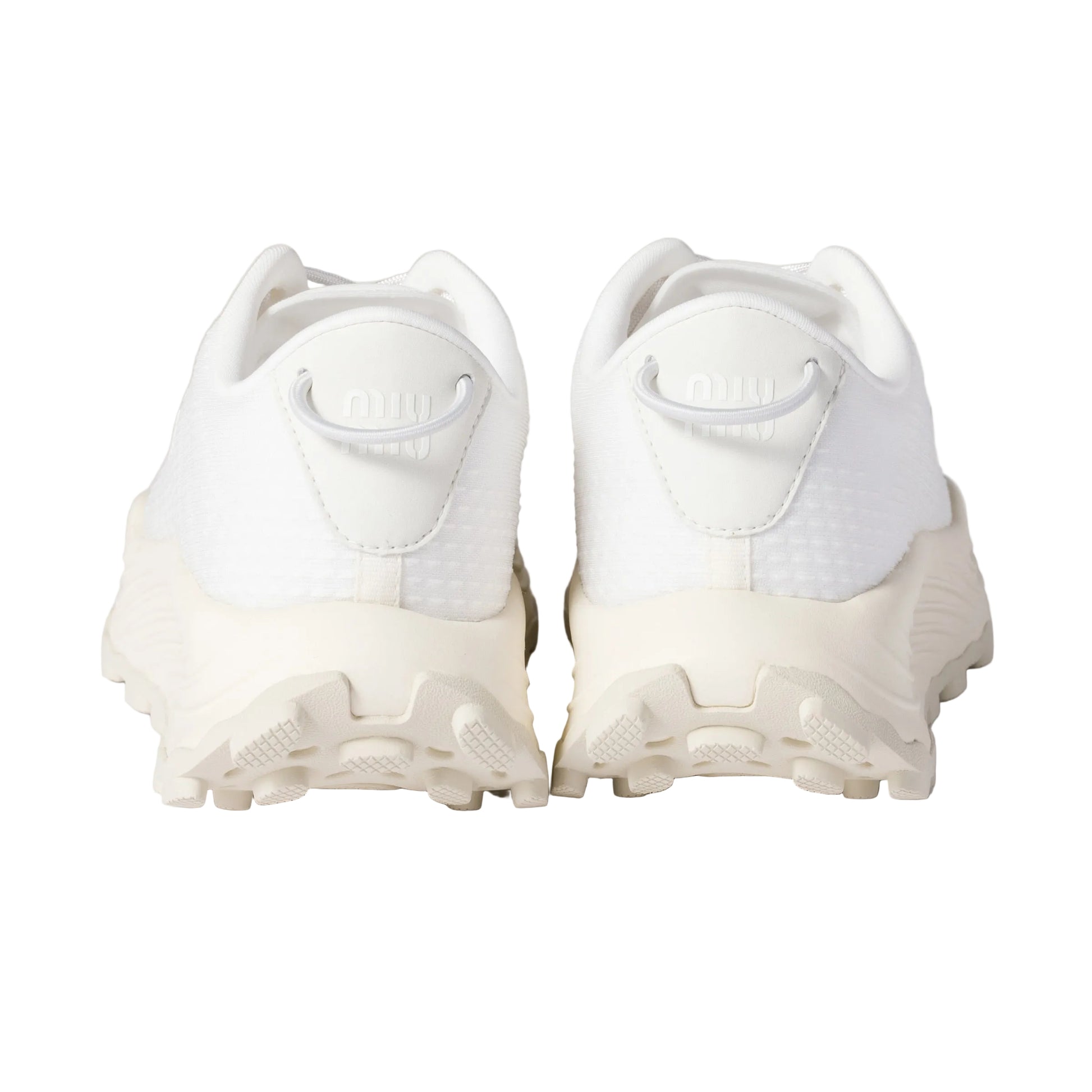 White athletic shoes with cleats on a light background