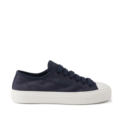 Navy blue sneaker with white sole on a white background