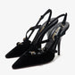 Black high-heeled shoes with thin straps on a white background