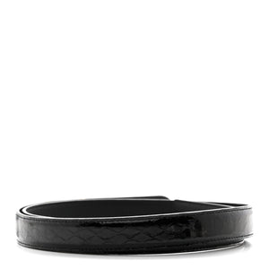 Black belt with woven pattern on a white background
