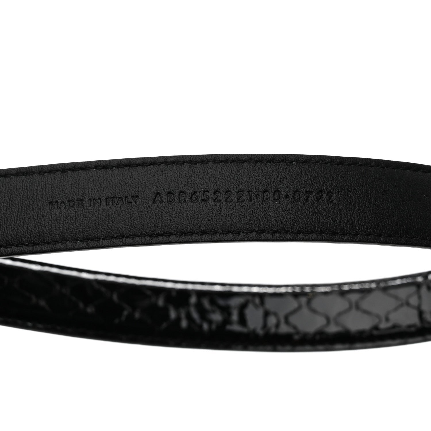 Black belt with a patterned strap on a white background