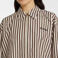 Person wearing a brown and white striped shirt with 'niumu' branding.