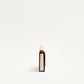 Small bottle with a white cap on a light beige background