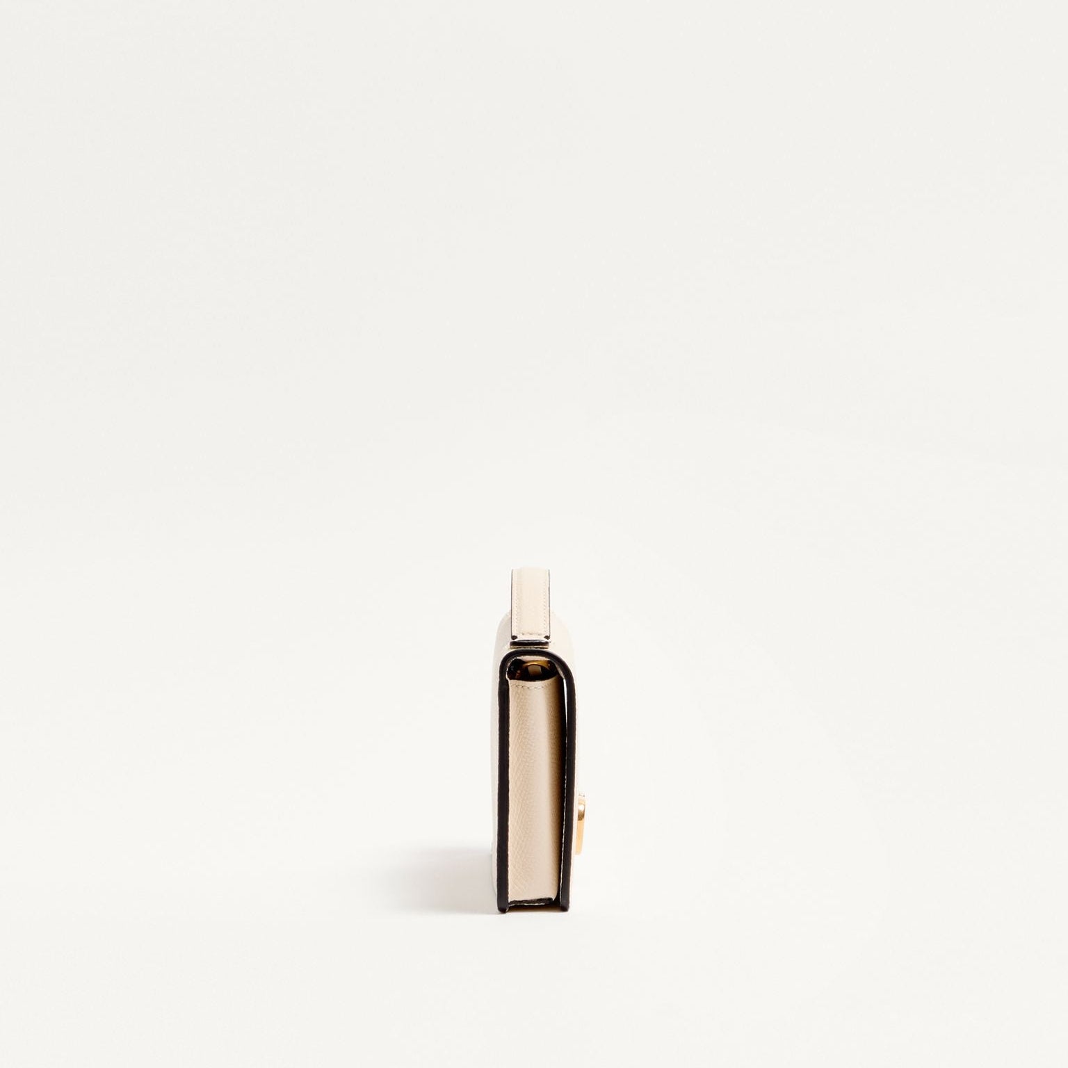 Small bottle with a white cap on a light beige background