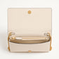 Beige handbag with gold chain strap on a white background