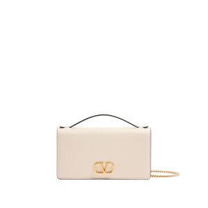 Cream-colored handbag with a gold chain and logo on a white background